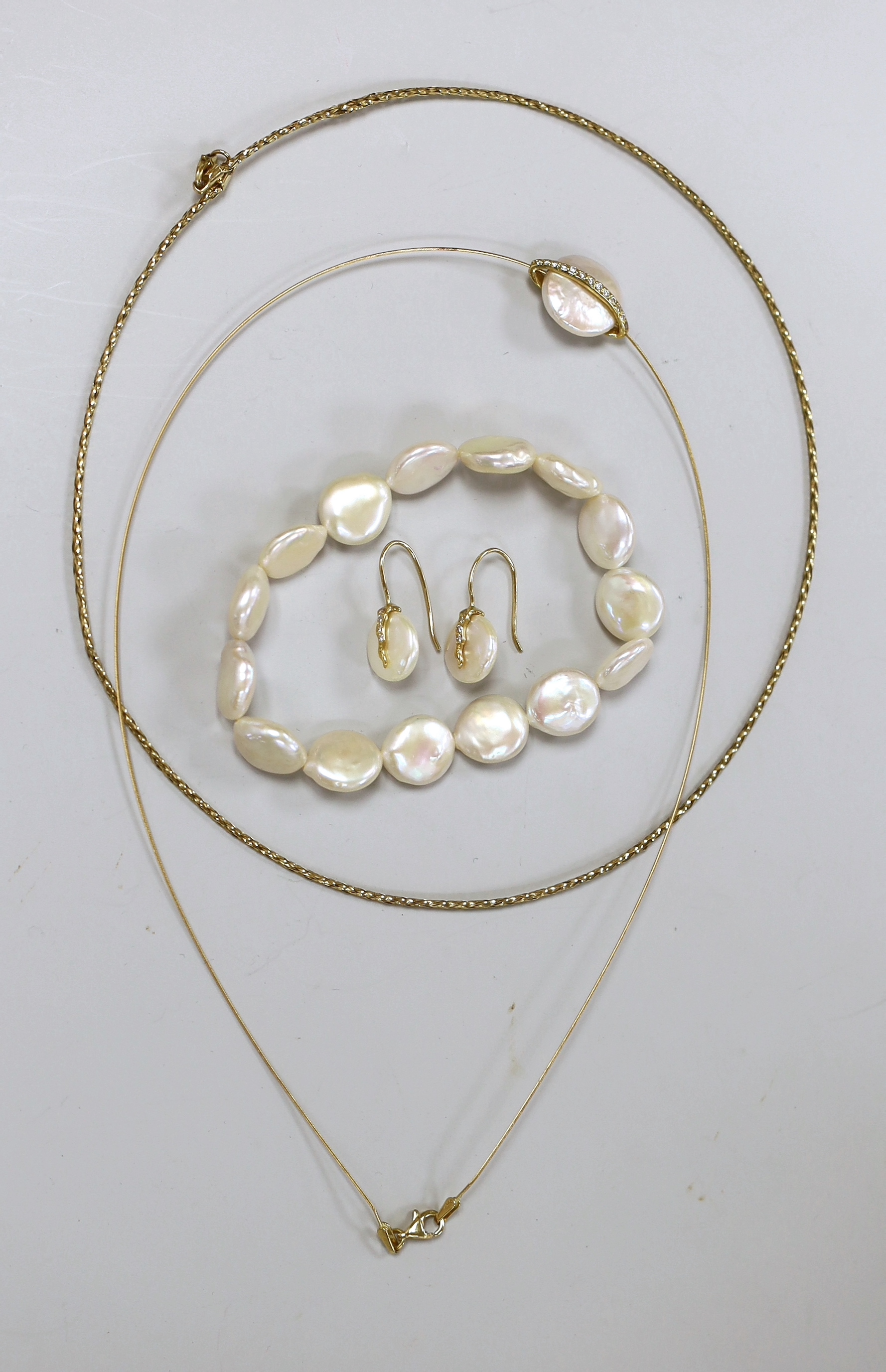 A modern suite of 750, diamond and button cultured pearl set jewellery, comprising a necklet and pair of earrings, together with a mother of pearl bracelet and a 375 necklet.